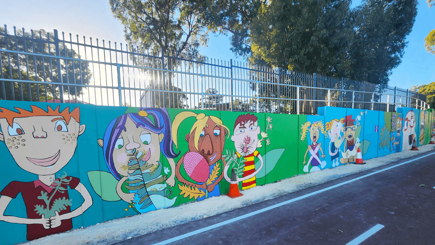 Completed king wall post retaining wall with colourful mural